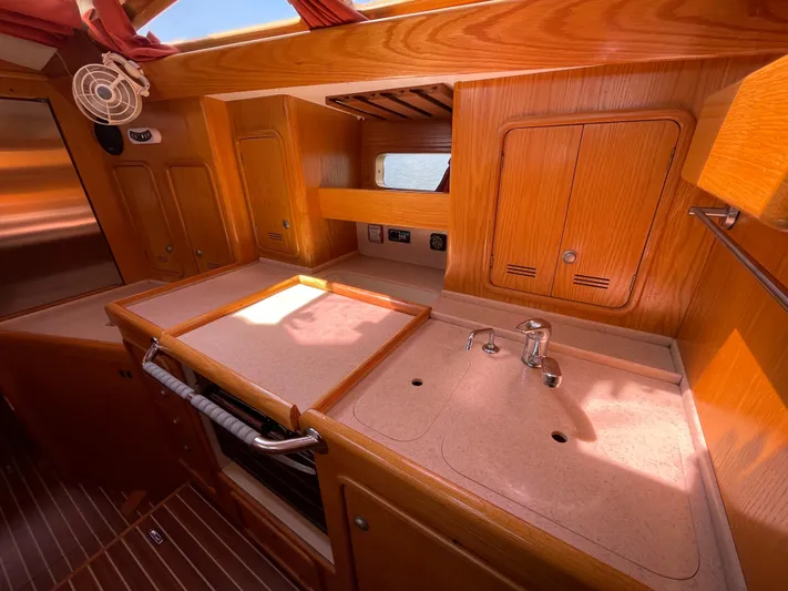Chandelle Yacht Photos Pics Alubat OVNI 435 yacht kitchen interior with wooden cabinets and countertop, 2008 model.
