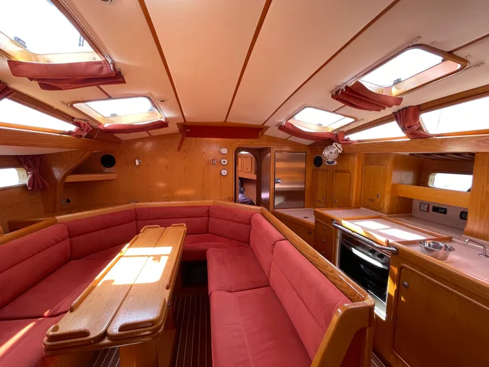 Chandelle Yacht Photos Pics Interior of 2008 Alubat OVNI 435 yacht with red seating and wooden finishes.