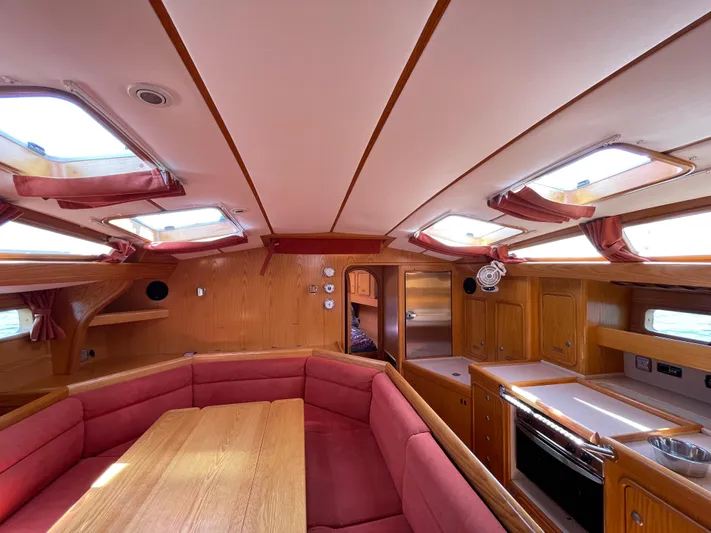 Chandelle Yacht Photos Pics Interior of 2008 Alubat OVNI 435 yacht with wood finish and red seating.