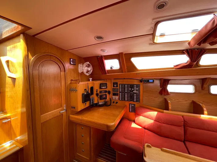 Chandelle Yacht Photos Pics Interior of 2008 Alubat OVNI 435 yacht with red seating and navigation equipment.