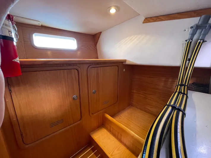 Chandelle Yacht Photos Pics Interior of 2008 Alubat OVNI 435 sailboat with wooden cabinetry and steps.