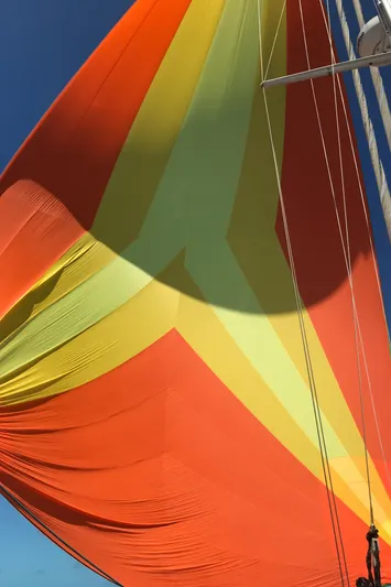 Chandelle Yacht Photos Pics Brightly colored sail of a 2008 Alubat OVNI 435 yacht against a clear blue sky.