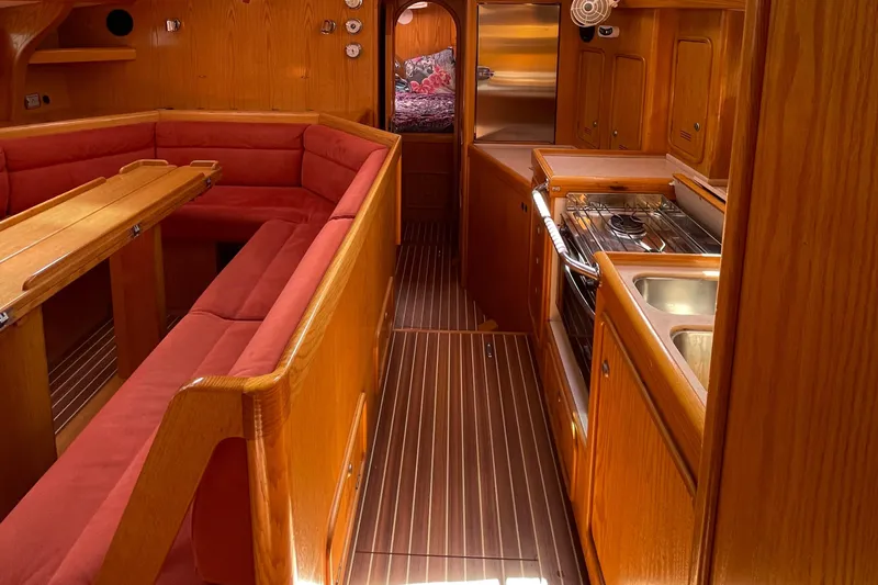 Chandelle Yacht Photos Pics Interior of 2008 Alubat OVNI 435 yacht with wood finish and red seating.