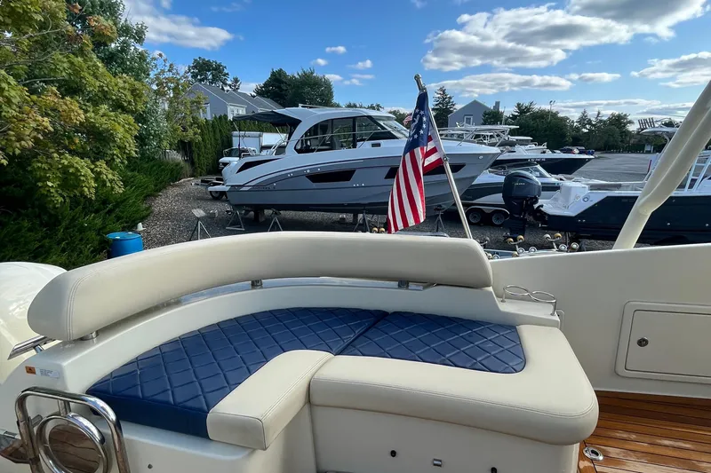  Yacht Photos Pics 2016 Chris-Craft Launch 36 boat with American flag, docked near other boats.