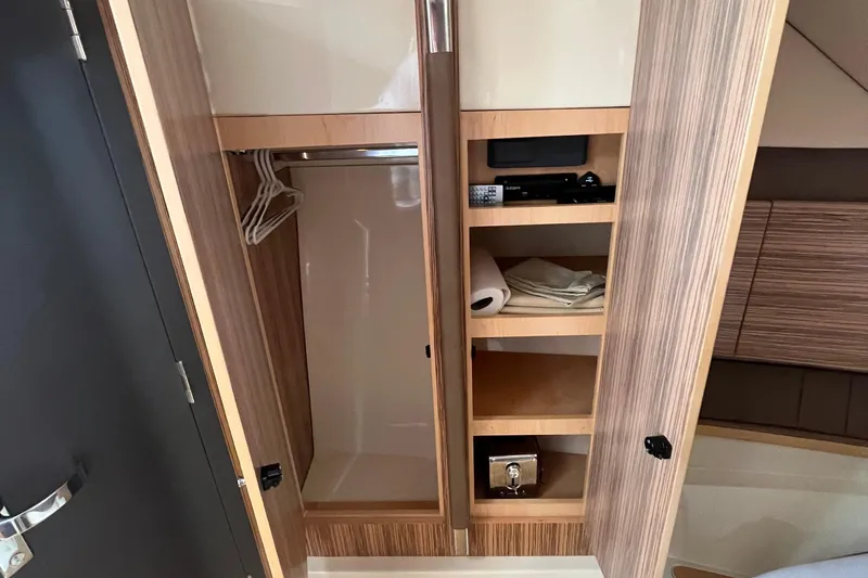  Yacht Photos Pics 2016 Chris-Craft Launch 36 interior closet with shelves and hangers.