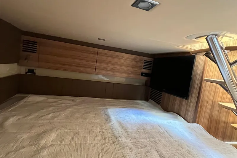  Yacht Photos Pics Luxurious interior cabin of 2016 Chris-Craft Launch 36 with wood paneling and TV.