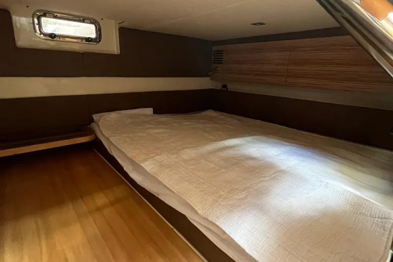  Yacht Photos Pics 2016 Chris-Craft Launch 36 cabin interior with bed, wooden accents, and window.