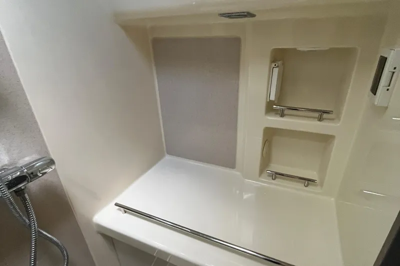  Yacht Photos Pics 2016 Chris-Craft Launch 36 bathroom with shower and storage shelves.
