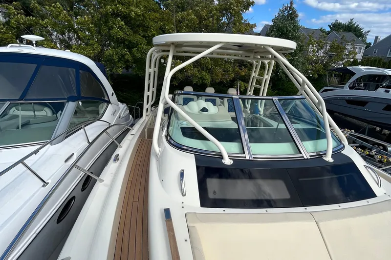  Yacht Photos Pics 2016 Chris-Craft Launch 36 boat with sleek design and spacious deck, docked alongside other vessels.