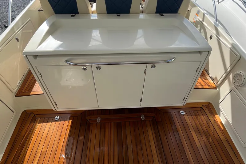  Yacht Photos Pics 2016 Chris-Craft Launch 36 interior with wooden flooring and storage cabinet.