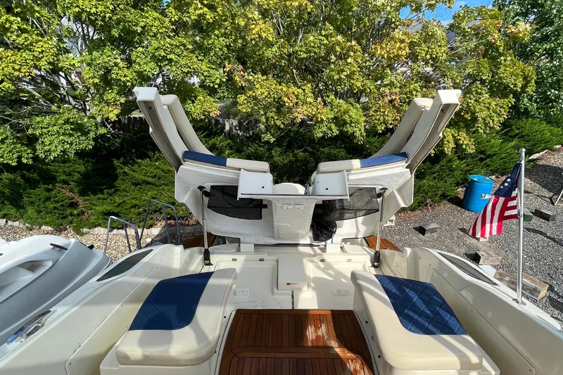  Yacht Photos Pics 2016 Chris-Craft Launch 36 boat with seating, American flag, and lush greenery background.