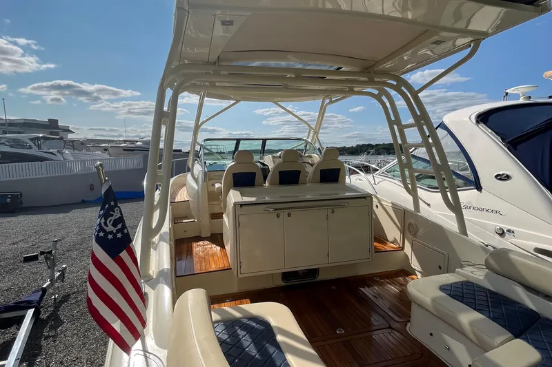  Yacht Photos Pics 2016 Chris-Craft Launch 36 boat interior with seating and American flag, docked under a sunny sky.