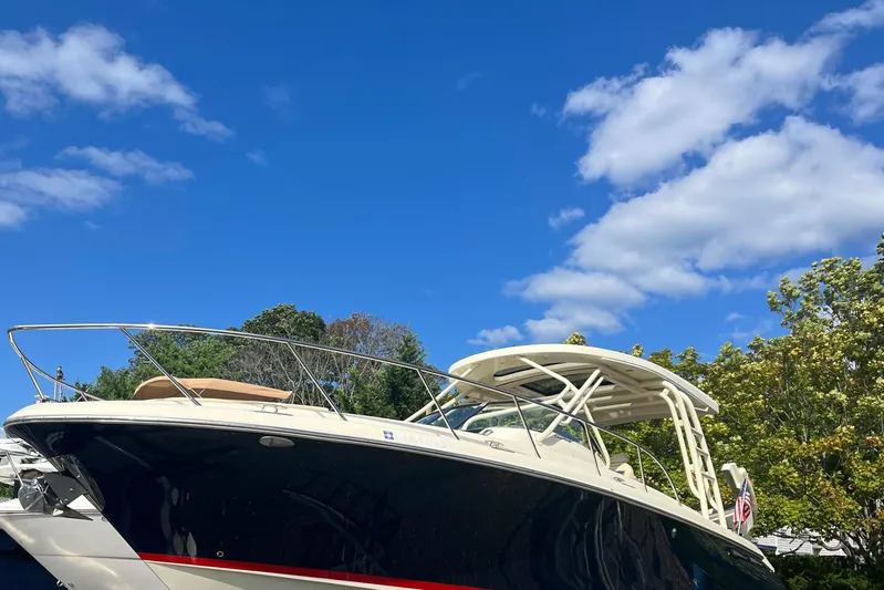  Yacht Photos Pics 2016 Chris-Craft Launch 36 boat under clear blue sky with lush greenery.