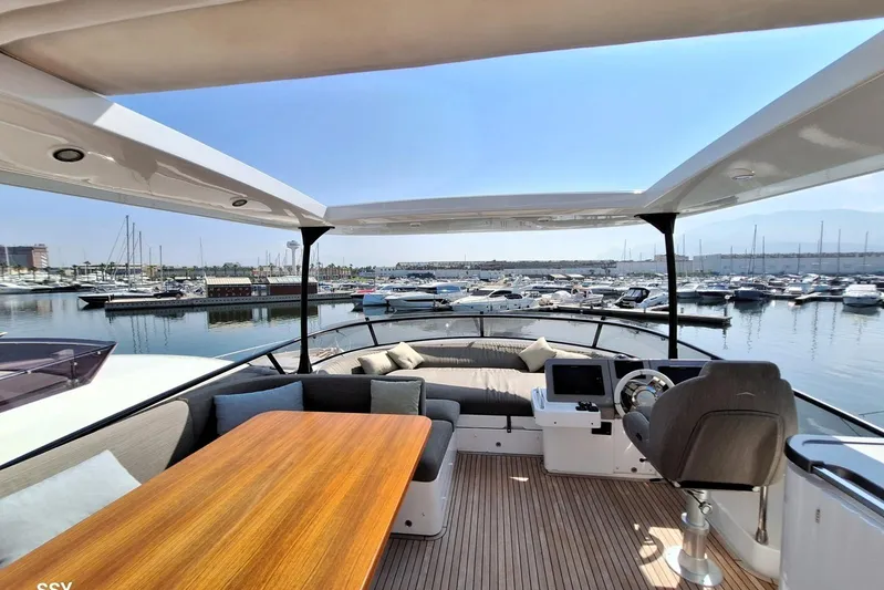 Soul Yacht Photos Pics Luxurious 2022 Azimut Magellano 66 yacht interior with elegant seating and marina view.