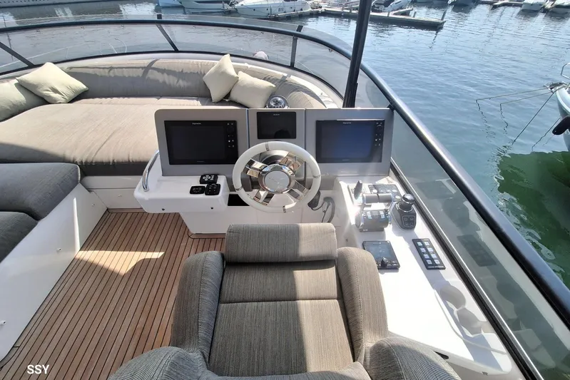 Soul Yacht Photos Pics Luxurious helm of 2022 Azimut Magellano 66 yacht with modern controls and seating.