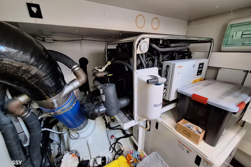 Soul Yacht Photos Pics Engine room of 2022 Azimut Magellano 66 yacht, featuring mechanical components and storage.