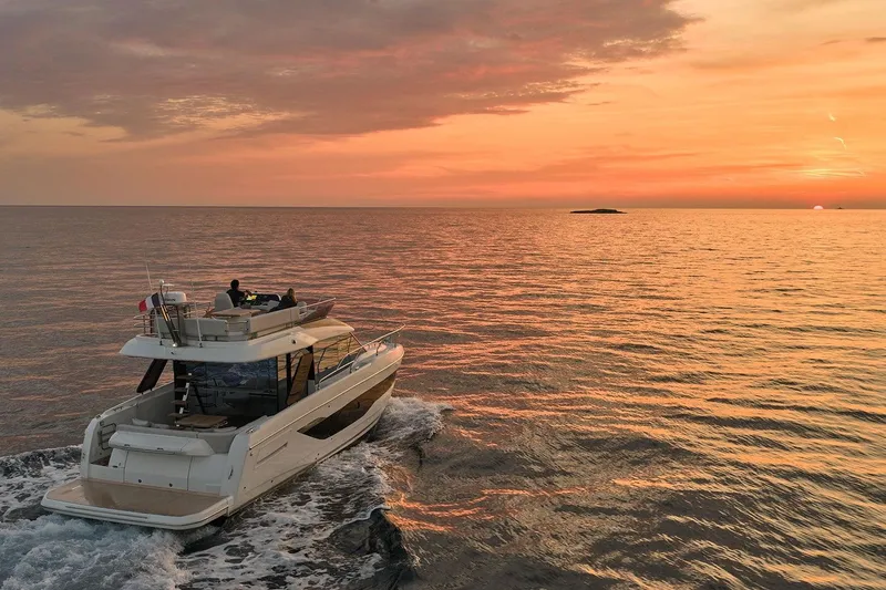  Yacht Photos Pics 2024 Prestige F4.3 yacht cruising at sunset on open sea.