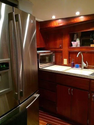 Temptress Yacht Photos Pics 1971 Hatteras 58 Motor Yacht kitchen with stainless steel appliances.