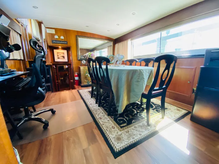 Temptress Yacht Photos Pics Interior of 1971 Hatteras 58 Motor Yacht, dining area with table and chairs.