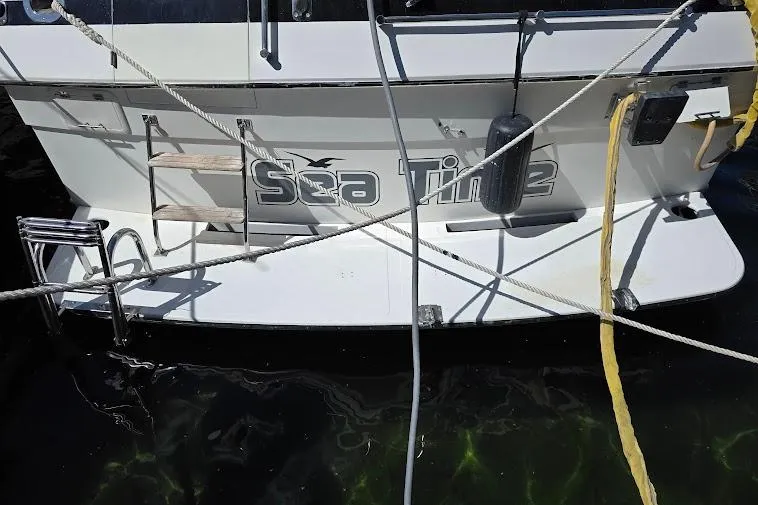  Yacht Photos Pics 1993 McKinna 48 Pilothouse yacht named "Sea Time" docked with ropes and ladder.