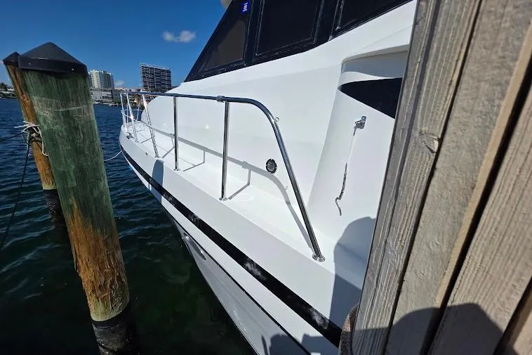  Yacht Photos Pics 1993 McKinna 48 Pilothouse yacht docked, showcasing sleek white exterior and railing.