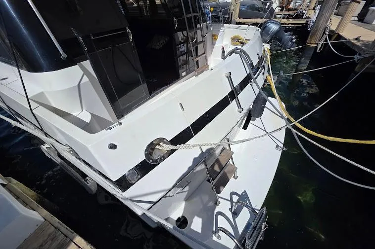  Yacht Photos Pics 1993 McKinna 48 Pilothouse yacht docked, showing rear deck and mooring ropes.