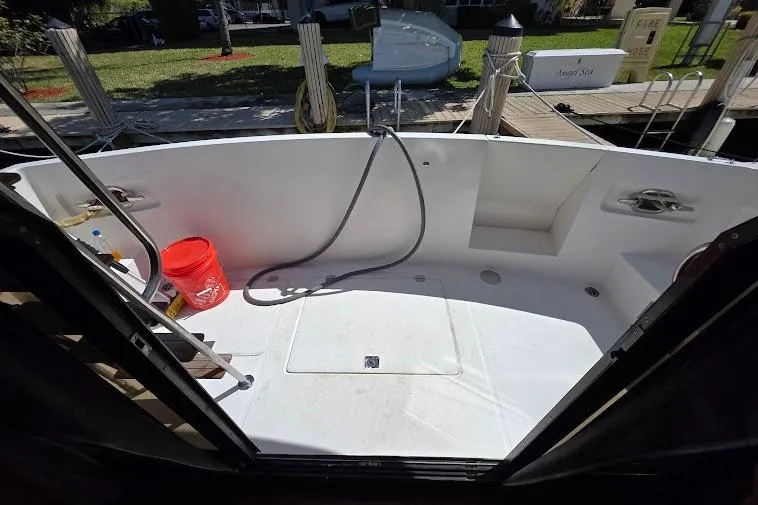  Yacht Photos Pics 1993 McKinna 48 Pilothouse boat deck with hose and red bucket, docked at marina.