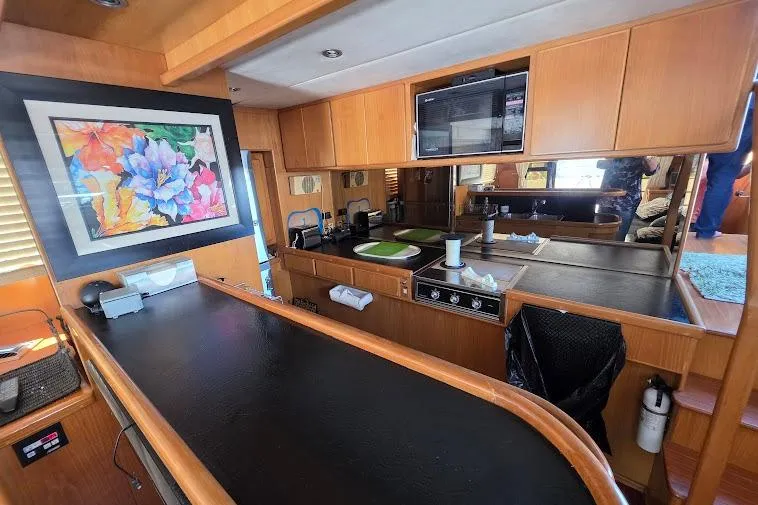  Yacht Photos Pics Interior of 1993 McKinna 48 Pilothouse yacht with modern kitchen and vibrant artwork.
