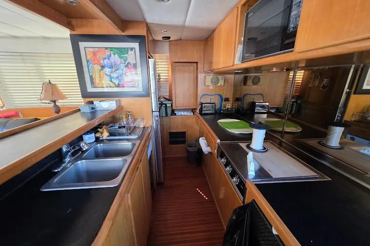  Yacht Photos Pics 1993 McKinna 48 Pilothouse kitchen with wood cabinetry, dual sinks, and modern appliances.