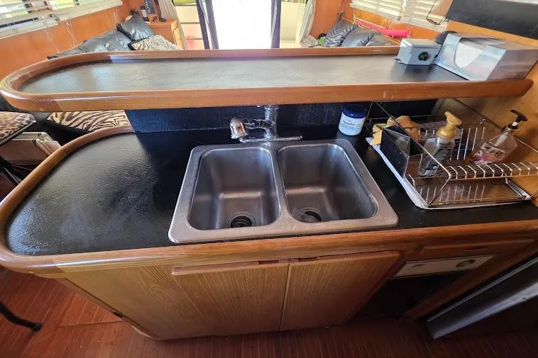  Yacht Photos Pics 1993 McKinna 48 Pilothouse kitchen with dual sinks and wooden cabinetry.