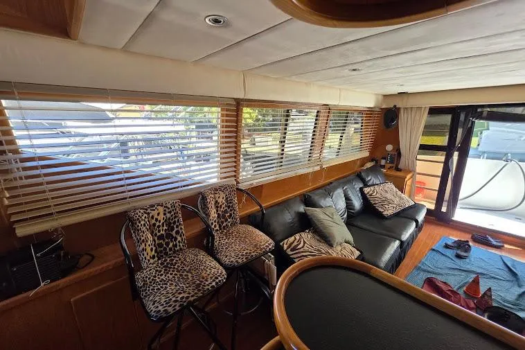  Yacht Photos Pics Interior of 1993 McKinna 48 Pilothouse with leopard print stools and black leather sofa.