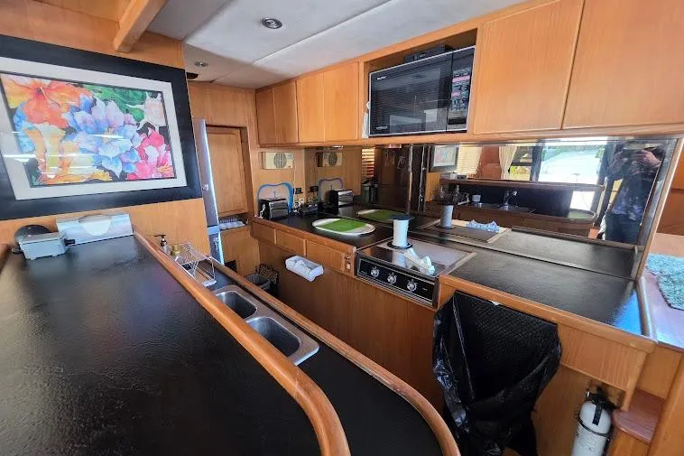  Yacht Photos Pics Interior of 1993 McKinna 48 Pilothouse yacht with modern kitchen and colorful artwork.