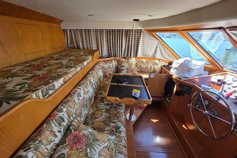  Yacht Photos Pics 1993 McKinna 48 Pilothouse interior with floral upholstery and wooden accents.