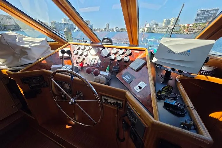  Yacht Photos Pics Pilothouse of 1993 McKinna 48, featuring steering wheel, controls, and Garmin navigation system.