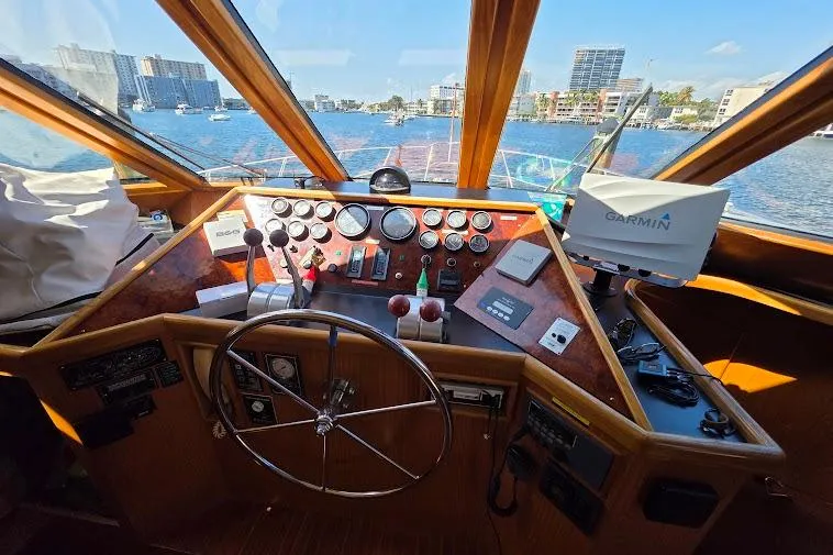  Yacht Photos Pics Pilothouse interior of 1993 McKinna 48, featuring steering wheel and navigation equipment.