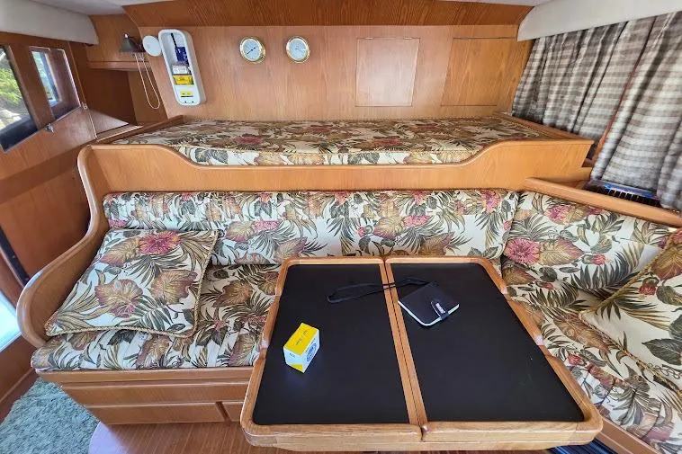  Yacht Photos Pics 1993 McKinna 48 Pilothouse interior with floral upholstery and wooden accents.