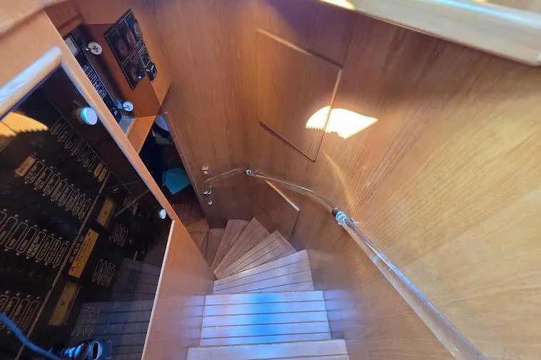  Yacht Photos Pics Staircase inside 1993 McKinna 48 Pilothouse yacht with wooden finish and control panel.