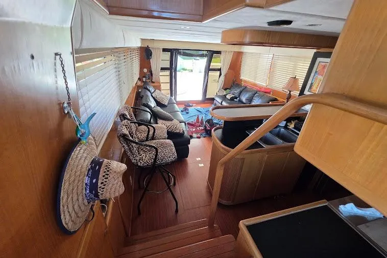  Yacht Photos Pics Interior of 1993 McKinna 48 Pilothouse yacht with cozy seating and wooden finishes.