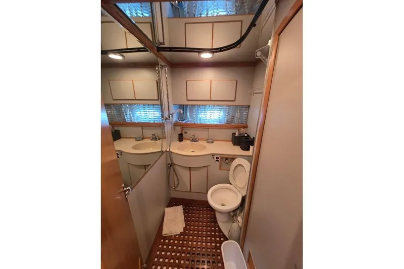  Yacht Photos Pics Bathroom interior of 1993 McKinna 48 Pilothouse yacht, featuring dual sinks and toilet.