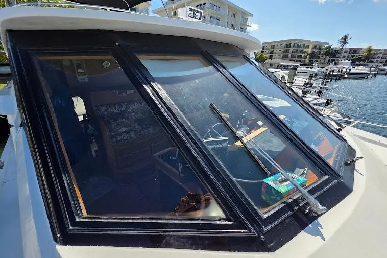  Yacht Photos Pics 1993 McKinna 48 Pilothouse yacht with large windows, docked in a marina.