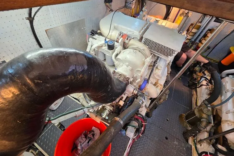  Yacht Photos Pics Engine room of a 1993 McKinna 48 Pilothouse yacht, featuring mechanical components and hoses.