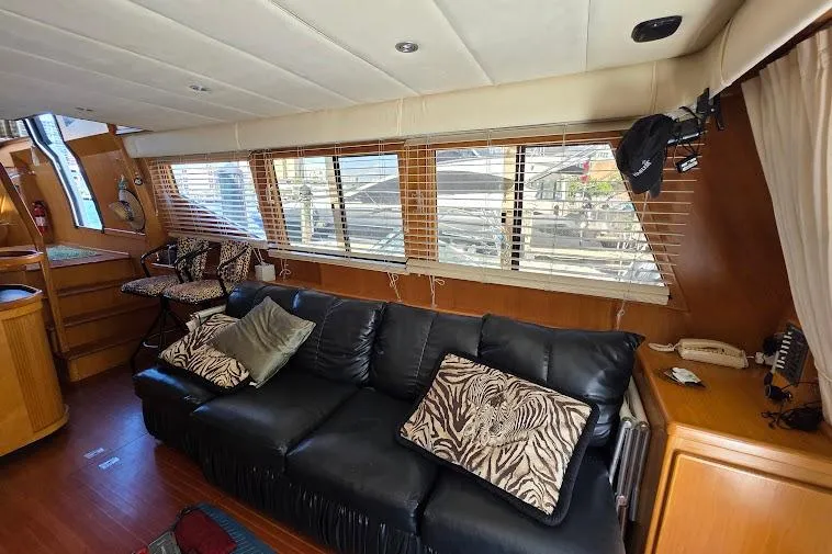  Yacht Photos Pics Luxurious interior of a 1993 McKinna 48 Pilothouse yacht with leather seating and zebra-patterned cushions.