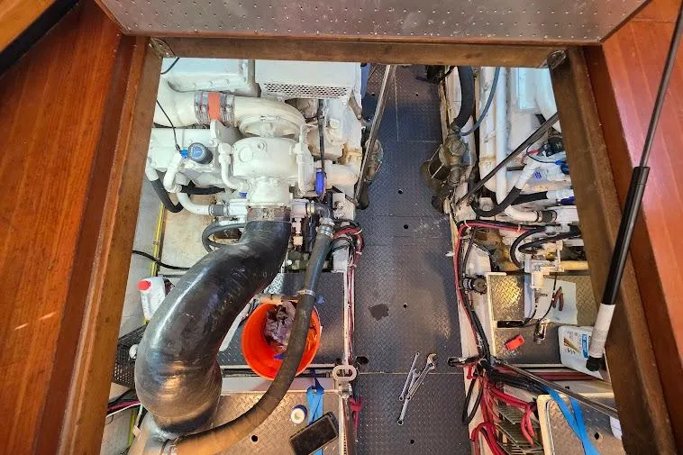 Yacht Photos Pics Engine room of a 1993 McKinna 48 Pilothouse, featuring mechanical components and tools.
