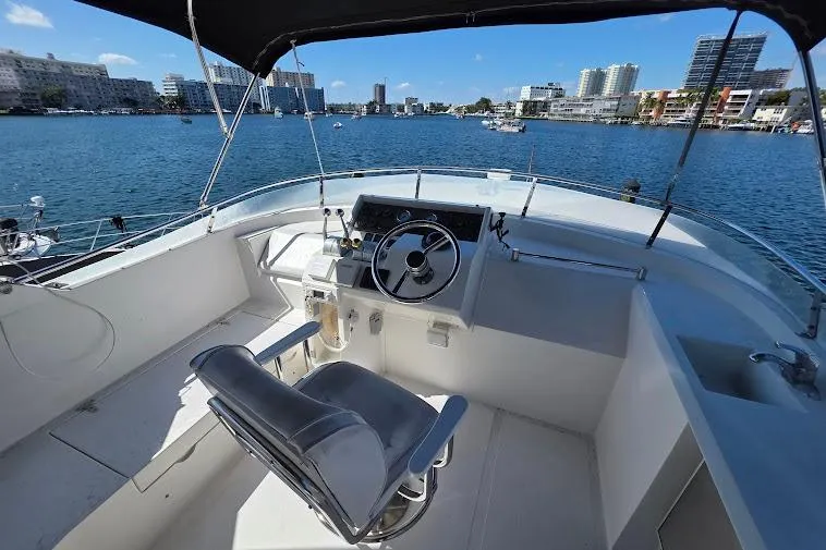  Yacht Photos Pics 1993 McKinna 48 Pilothouse helm with waterfront cityscape view.