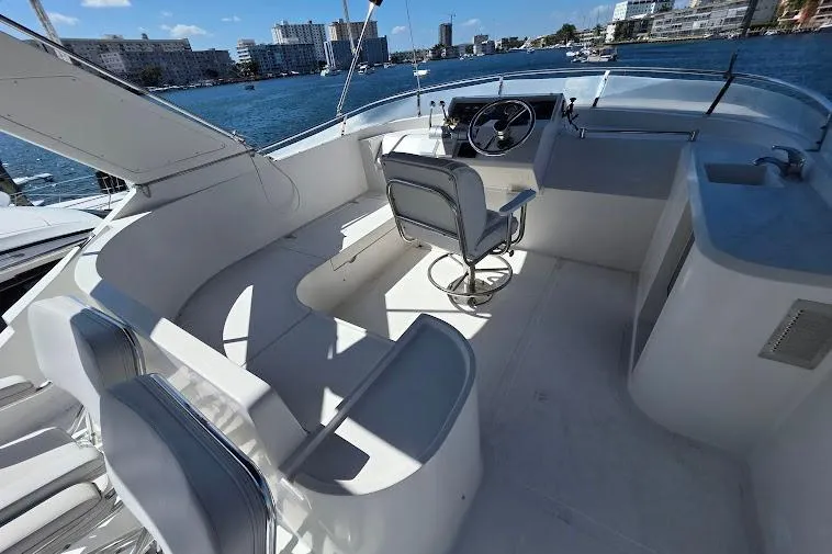  Yacht Photos Pics 1993 McKinna 48 Pilothouse yacht interior with helm, seating, and waterfront view.