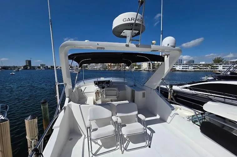  Yacht Photos Pics 1993 McKinna 48 Pilothouse yacht docked, featuring spacious deck and modern navigation equipment.
