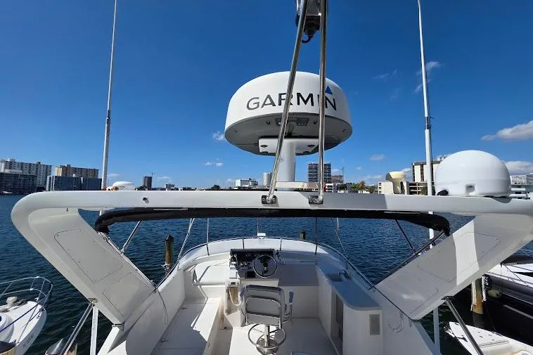  Yacht Photos Pics 1993 McKinna 48 Pilothouse yacht with Garmin radar, docked in a marina under clear blue skies.