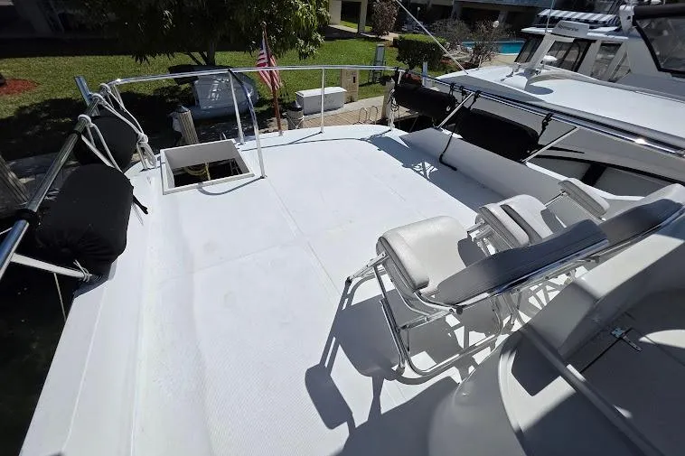  Yacht Photos Pics 1993 McKinna 48 Pilothouse yacht deck with seating and railing.