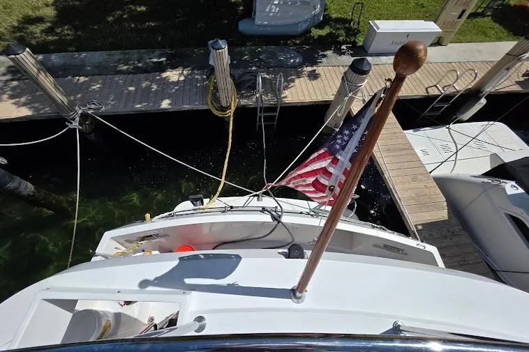  Yacht Photos Pics 1993 McKinna 48 Pilothouse yacht docked, displaying an American flag, viewed from above.