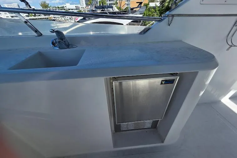  Yacht Photos Pics 1993 McKinna 48 Pilothouse yacht with sink and mini fridge on deck.